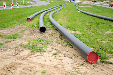 Image showing electricity cable wire protective tube on meadow 