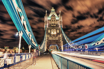 Image showing Detail of Tower Bridge in London at night with car light trail -
