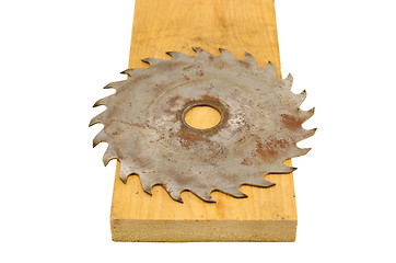 Image showing circular saw disk on wood board closeup on white 