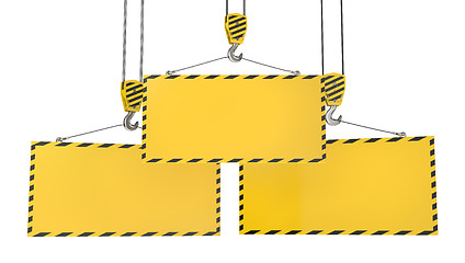 Image showing Three crane hooks with blank yellow plates