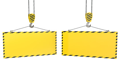 Image showing Two crane hooks with blank yellow plates