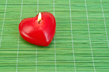 Image showing Heart of candles on bamboo