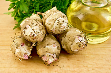 Image showing Jerusalem artichokes with oil on board