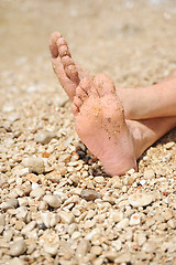 Image showing Relaxation on beach, detail of male feet