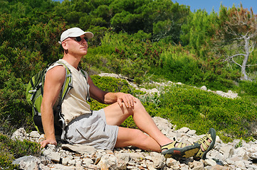 Image showing Outdoor man resting on rock after hiking, Croatia