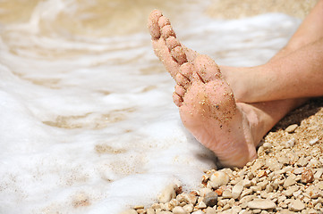 Image showing Relaxation on beach, detail of male feet