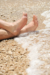 Image showing Relaxation on beach, detail of male feet