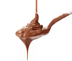 Image showing Melted chocolate flowing on a spoon