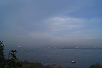 Image showing Bosporus in mist with passenger ships far away