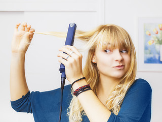 Image showing teenager smooting her hair