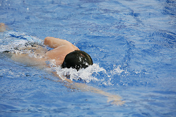 Image showing Young man swimming the front crawl in a pool 