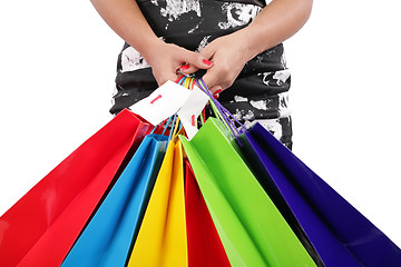 Image showing woman hands holding shopping bags isolated on white. Focus on ha