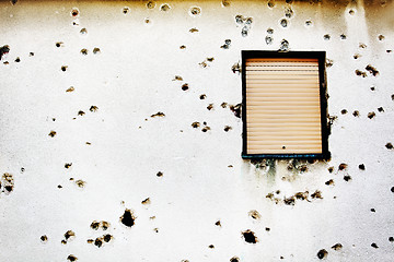 Image showing Bullet holes in a house facade