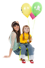 Image showing studio shot of mother and daughter with balloons