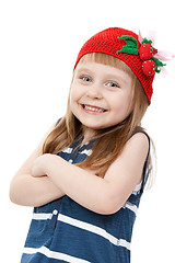 Image showing beautiful little girl in a red hat with a pattern of strawberrie