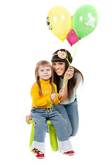 Image showing studio shot of mother and daughter with balloons