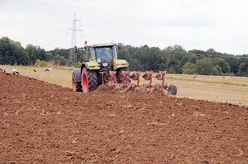 Image showing tractor plow autumn field stork birds 