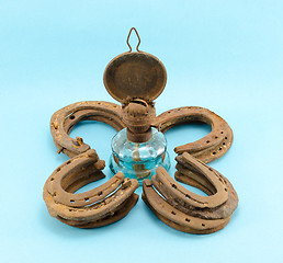 Image showing retro kerosene lamp  clover rusty horse shoes blue 