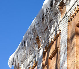 Image showing Snow-covered roof with icicles