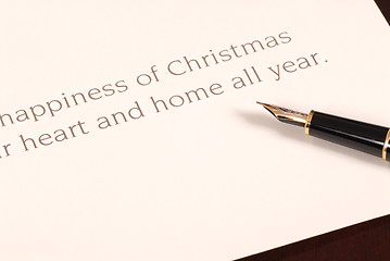 Image showing Christmas card waiting to be signed by a fountain pen