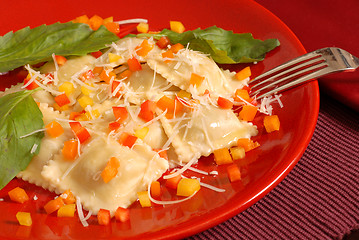 Image showing Ravioli topped with diced red, yellow and orange peppers with ba