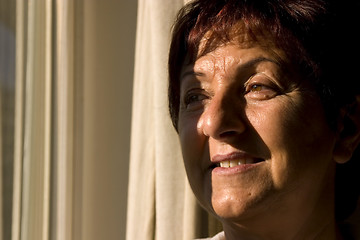 Image showing Woman looking out the window