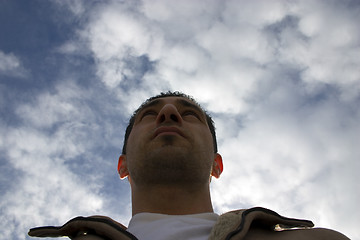 Image showing Man Looking up with the Clouds on the Background