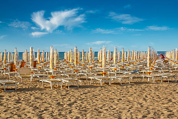 Image showing withdrawn umbrellas and sunlongers on the sandy beach