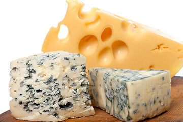 Image showing Different types of cheese on old wooden kitchen board