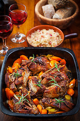 Image showing Roasted pork belly on vegetables with sauerkraut