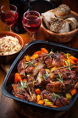 Image showing Roasted pork belly on vegetables with sauerkraut