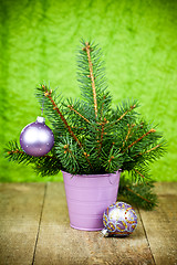 Image showing bucket with christmas fir tree and purple decorations 