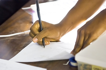 Image showing African-American writing on sheet of paper