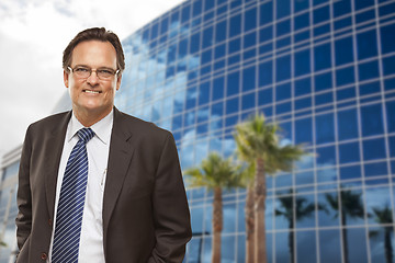 Image showing Handsome Businessman Smiling in Front of Building