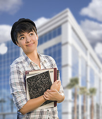 Image showing Mixed Race Female Student Holding Books in Front of Building