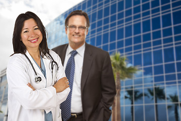 Image showing Hispanic Doctor or Nurse and Businessman in Front of Building