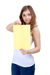 Image showing Lovely girl shows a blank A4 sheet of yellow