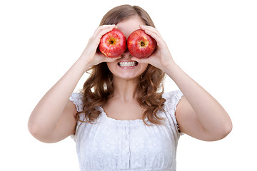 Image showing Woman holding two red apples for eyes