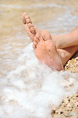 Image showing Relaxation on beach, detail of male feet