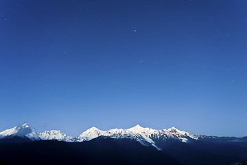 Image showing Snow mountain at dawn with stars