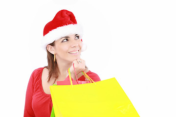 Image showing Attractive woman in Christmas cap hands packets, isolated on whi