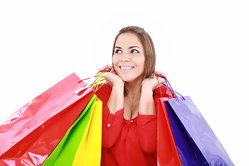 Image showing Shopping woman holding shopping bags looking up to the side on w