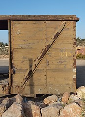 Image showing Detail of abandoned wooden railway car standing on props