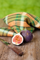 Image showing  fresh figs, old knife and chequered towel 