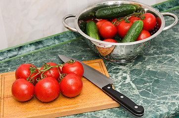 Image showing red tomato and knife on board