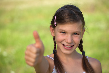 Image showing Young girl giving thumbs up