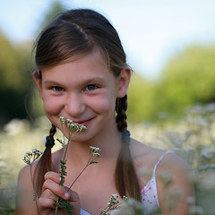 Image showing Young girl on a flower meadow