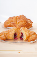 Image showing croissant French brioche filled with berries jam