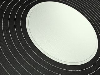 Image showing Black and white stitched circle shape on leather