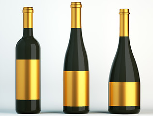 Image showing Three black bottles for wine with golden labels 